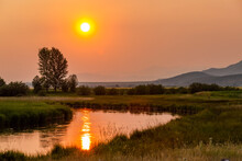 USA, Idaho, Bellevue, Sunset Reflecting In Spring Creek In Rural Landscape