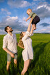 © Tetra Images - Parents playing with baby son (12-17 months) in agricultural field