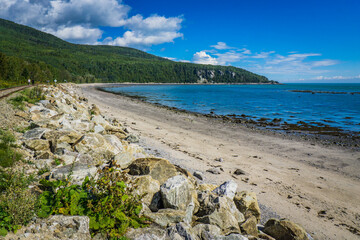 Wall Mural - View on the St Lawrence river and the Cap-Aux-Oies beach on a summer day in Charlevoix, a region of Quebec, Canada