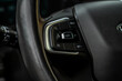 © Roman - Cruise control switch closeup. Adaptive cruise control leaver. Cruise control on steering wheel.