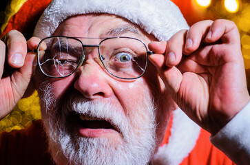 Wall Mural - Santa with broken eyeglasses. Christmas. New year. Santa Claus looking through cracked glasses. Closeup.