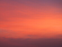 Background Image Of Sky With Beautiful Pastel Pink And Orange Clouds In The Evening As The Sun Sets. Calm Sky In Winter Evening
