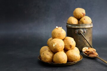 Indian Traditional Sweet Food Besan ke Laddu. Made using gram flour, sugar, and ghee. Indian festival sweet. Diwali faral or snacks. copy space. Gram flour sweet Ladoo. 