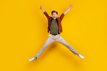 Full Body Photo Of Young Excited Guy Have Fun Jump Up Energetic Free-time Isolated Over Yellow Color Background