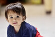 © Rajesh - Indian baby girl crawling on the floor and looking directly at the camera