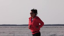 Asian Woman Jogging Across The Bonneville Salt Flats Flats In Utah. Slow Motion.