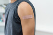 © Daniel Ernst - Close up - plaster on strong arm of man after third vaccination against Covid 19
