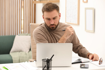 Poster - Young man working with laptop at home