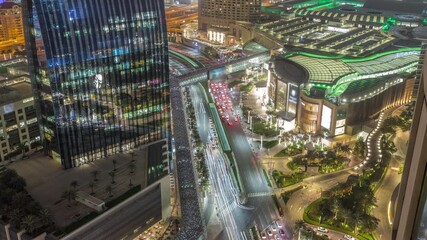 Wall Mural - Aerial panorama of Downtown Dubai with shopping mall and traffic on a street night timelapse from above, UAE