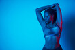 © ADDICTIVE STOCK - Fit African American woman doing overhead triceps stretch in studio