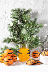 Wall Mural - orange mandarin cocktail in glass with black stripes and cookies. Christmas holiday drink. Concept for children new year