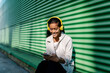 © VISTA by Westend61 - Smiling woman with headphones using mobile phone on bench