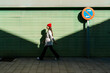 © VISTA by Westend61 - Woman wearing knit hat walking on footpath