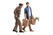 © Ljupco Smokovski - Young man carrying grocery bags and walking with a senior man