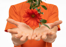 White Man Orange Flower Hovering Over His Hands With Orange Shirt Isolated On White Background