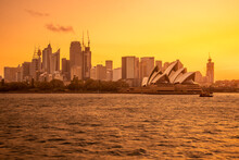 Spectacular Orange Sunset From The Skyline Of Sydney And The Opera House. View From The Sea