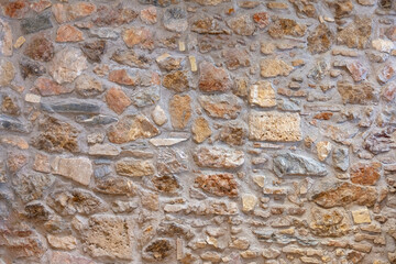 Wall Mural - Stone wall texture background. Old stonewall traditional pattern building facade, natural material