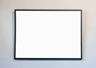 Empty frame on white wall background, copy space. Poster mockup. Black, modern, minimal border