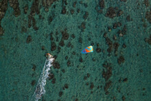 Aerial View Of A Person Doing Kite Surfing Along The Coast At Plage De La Saline Beach, Reunion.