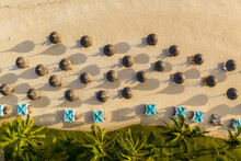 Aerial View Of A Tropical Beach With Parasols At Poste De Flacq, Mauritius.