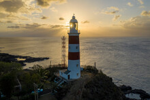 Aerial View Of A Lighthouse Along The Coastline At Sunset Near Albion, Mauritius.