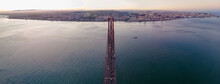 Panoramic Aerial View Of The Highway Road On April 25th Bridge Crossing Tagus River With Lisbon Downtown In Background, Lisbon, Portugal.