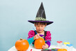 © M-image - young girl painting pumpkin for celebrating halloween party