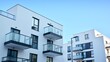 © Grand Warszawski - Facade of a modern apartment condominium in a sunny day. Modern condo buildings with huge windows and balconies.