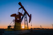© 欣谏 - Oil pumps are running in the sunset at the oil field. On the Bohai coast of China.