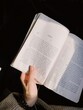© Scopio - Cropped image of hand holding an open book