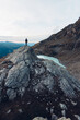 © Scopio - Man standing on waterside of frozen lake in the mountain
