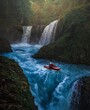 Person kayaking on waterfalls