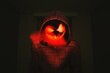 © Scopio - Person in hoodie with jack o lantern mask