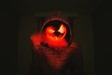Person In Hoodie With Jack O Lantern Mask