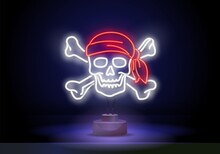 Skull In Red Bandana And Bones Neon Sign. Bright Skull Red Headband And Crossed Bones. Night Bright Advertisement, Illustration In Neon Style For Halloween And Bikers Style