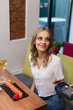 © LIGHTFIELD STUDIOS - smiling woman with credit card paying through terminal for sushi rolls and glass of wine