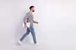 © Tetiana - Full body profile side photo of young man walk hold laptop representative isolated over grey color background