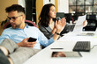© JustLife - Colleagues in office. Businesswoman and businessman discussing work in office