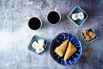 Wall Mural - Turkish delight. Baklava and coconut lukum with cups of coffee