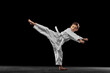 © master1305 - Dynamic portrait of little boy, young karate training alone isolated over white background. Concept of sport, education, skills