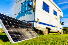 Camper With Portable Solar Panel On Coast
