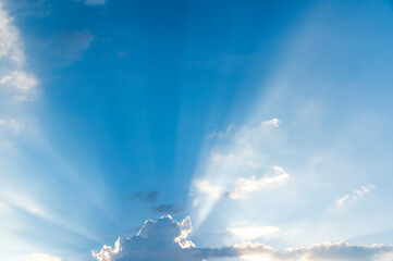 Wall Mural - sunset / sun rise sky with rays of light shining clouds and sky background and texture