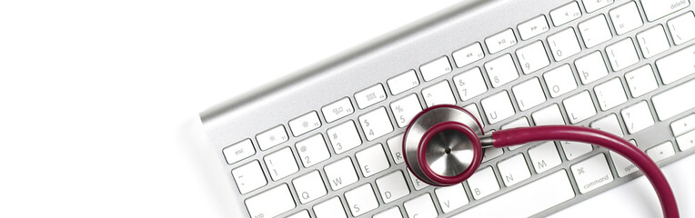 medical stethoscope on laptop keyboard. computer diagnostics or e-health concept                            