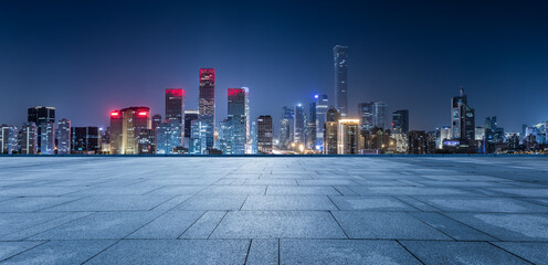 Panoramic skyline and modern commercial office buildings with empty square floors in Beijing at night