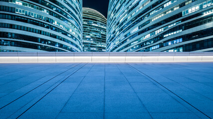 Panoramic skyline and modern commercial office buildings with empty square floors in Beijing at night