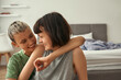 © Svitlana - Happy lesbian couple resting and hugging at home
