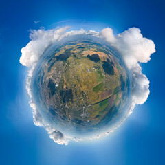 Aerial view from high altitude of little planet earth covered with white puffy cumulus clouds on sunny day