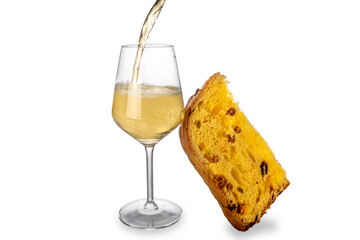 Champagne or sparkling wine splashing into glass with slice of panettone cake, isolated on white. Christmas, New Year celebrations concept. Copy space