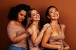 © iordani - young pretty asian, caucasian, african woman posing cheerful together on brown background, lifestyle diverse nationality people concept