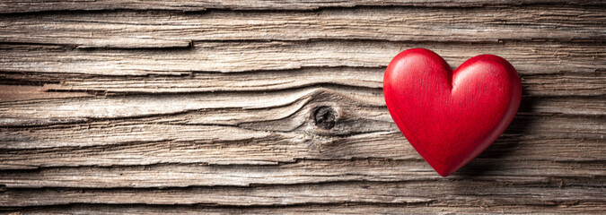 Wall Mural - single red wooden heart on rustic table background - valentine's day